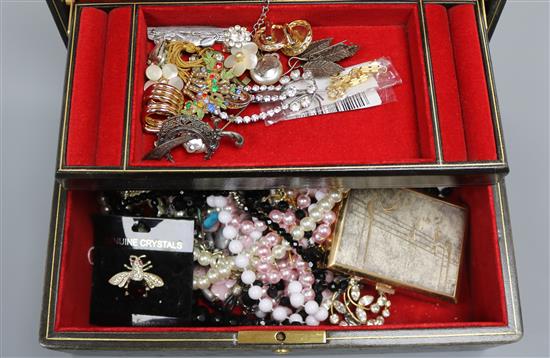 A group of assorted costume jewellery in a leather case.